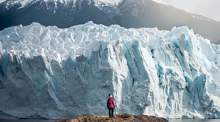 Woman standing in front of Perito Moreno Glacier in Argentina