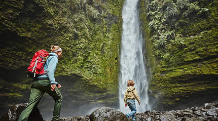 Mother and son on family vacation at Las Cascadas Waterfall in Chilean Patagonia