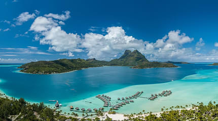 Aerial view of luxury overwater bungalows on Bora Bora island in French Polynesia.