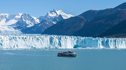 Ferry boat in front of Perito Moreno glacier in Argentina