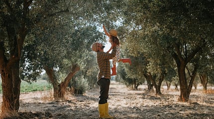 Father and daughter at an olive plantation
