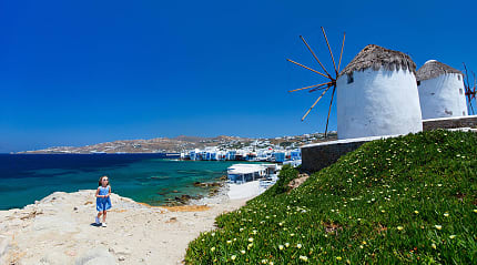Girl and windmills in Mykonos