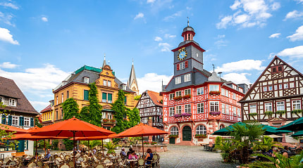 Cafes with outdoor seating and the half-timbered buildings in the market square of Heppenheim, Germany