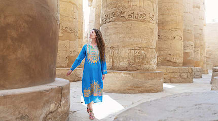 Woman marveling at hieroglyphics in Luxor, Egypt