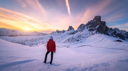 Woman hiking in the Dolomites during winter