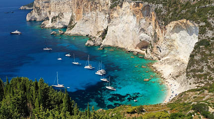 Boats moored at Erimitis Bay on Paxos Island, Greece
