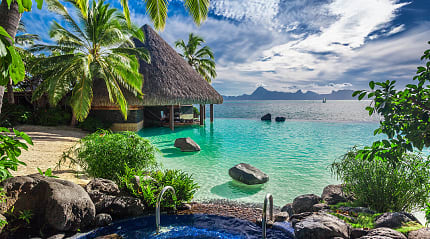 Infinity pool with jacuzzi over tropical ocean in Tahiti.