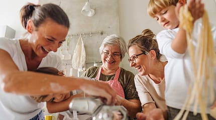 Family learning how to make pasta
