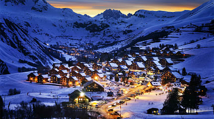 Cozy alpine village nestled in the French Alps, covered in snow.