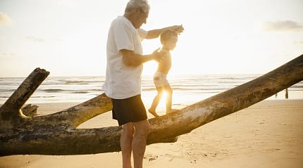 Grandfather with his grandson on the beach in Latin America