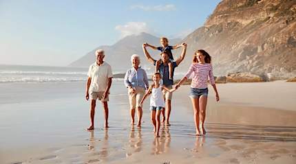 Three generations exhale together on a sunny South African beach