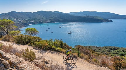 Biker with view of Elba Island in Tuscany, Italy