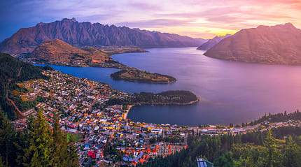 Aerial view of Queenstown at twilight with Lake Wakatipu and The Remarkable Mountains in New Zealand.