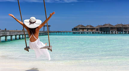 Woman enjoying a seaside swing in the Maldives