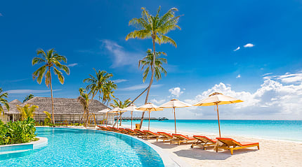 Luxury resort pool by the beach in the Maldives
