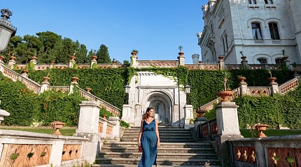 Woman walking the grounds at Castello di Miramare in Trieste, Italy