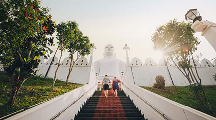Couple walking up the steps at Bahirawakanda Temple in Kandy, Sri Lanka