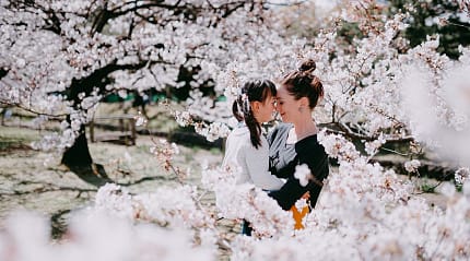 Mother and daughter sharing a moment amongst the cherry blossoms in Tokyo, Japan