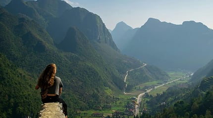 Woman sitting at an overlook along the