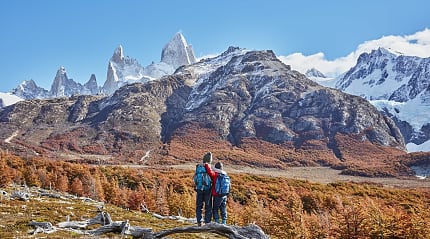 Brothers admiring the snowy peaks of Mount Fitz Roy, Patagonia, Argentina, during autumn