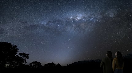 Couple stargazing in New Zealand
