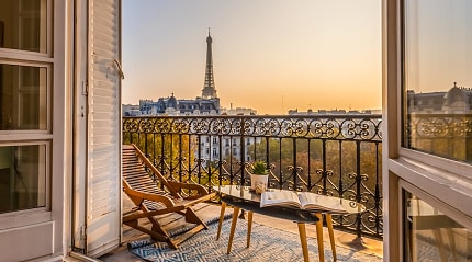Stunning view of the Eiffel Tower at sunset, from a Parisian balcony.