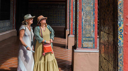 Senior travelers exploring the colorful tile work of the Convent of Santo Domingo in Lima, Peru