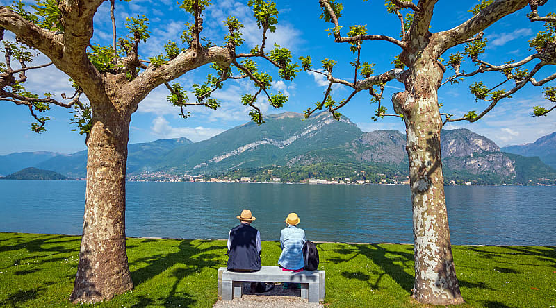 Senior couple enjoying the blue surface of Lake Como, Italy Senior couple enjoying the blue surface of Lake Como, Italy