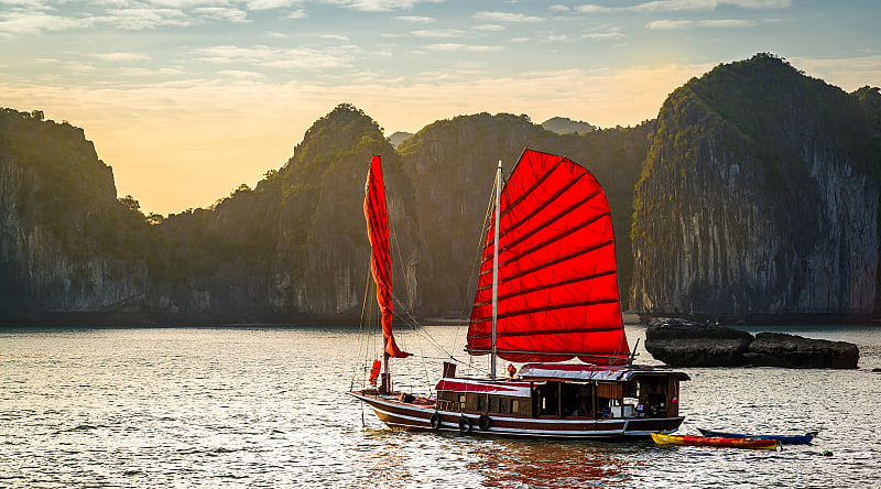 Ha Long Bay, Vietnam A red junk boat sailing in Ha Long Bay in Vietnam.