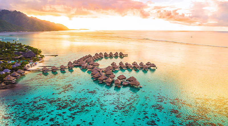 Overwater bungalows along coral reef in Moorea, French Polynesia Overwater bungalows along coral reef in Moorea, French Polynesia