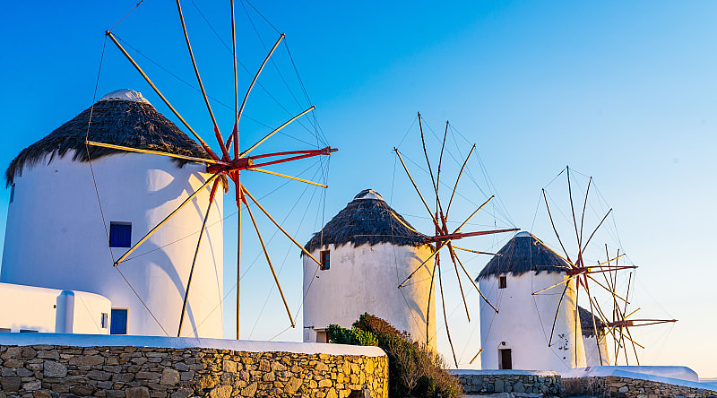 Mykonos, Greece Famous windmills of Mykonos town at romantic sunset, Greece