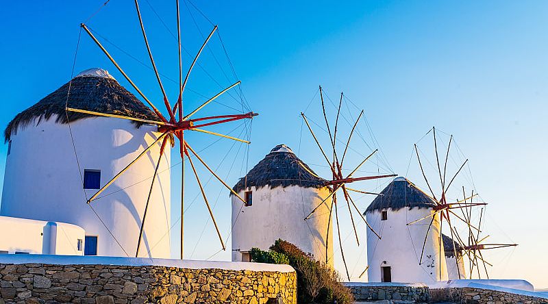 Mykonos, Greece Famous windmills of Mykonos town at romantic sunset, Greece