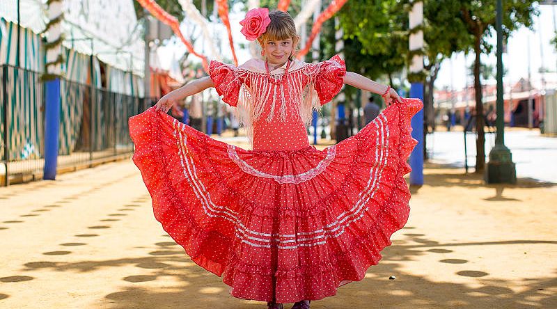 Young girl wearing traditional flamenco dress in Seville, Spain