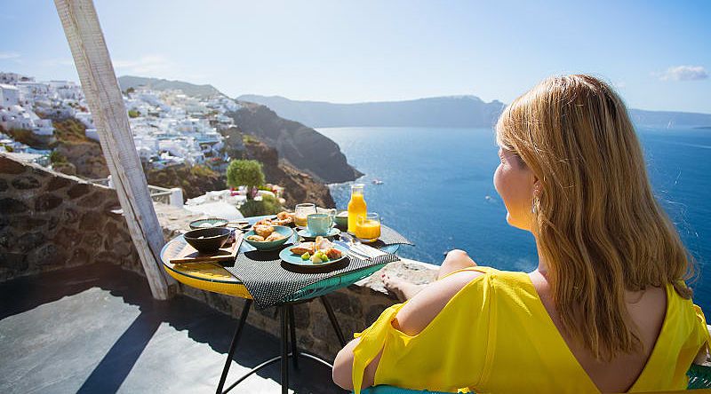 Highlights of Greece in 10 Days - Traveler enjoying the view from private terrace in Santorini