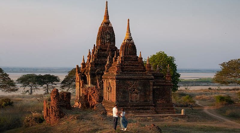 Couple enjoying view of a buddhist temple in Myanmar