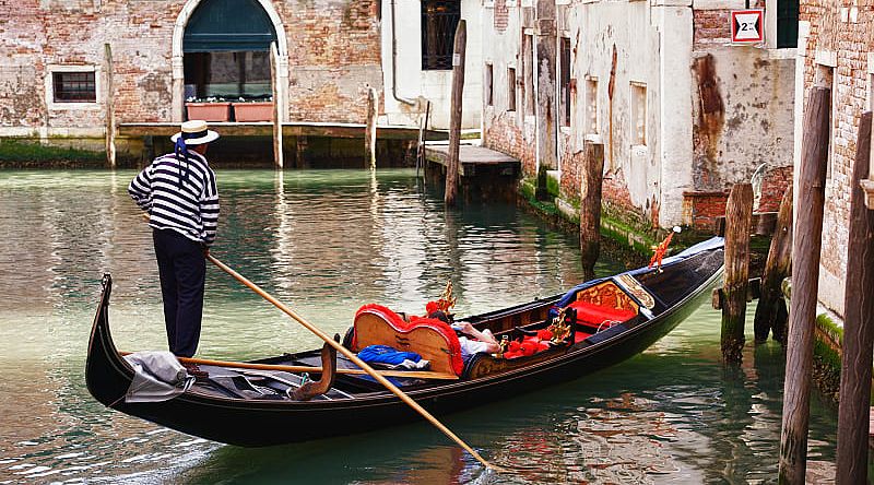 Gondolier on Venice canal in Italy Gondolier on Venice canal in Italy