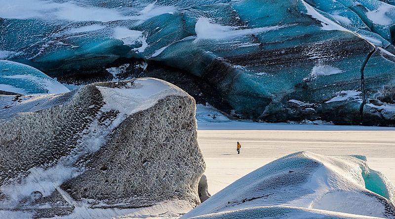 Hiker exploring Svínafellsjökull Glacier in Skaftafell Nataionall Park, Iceland