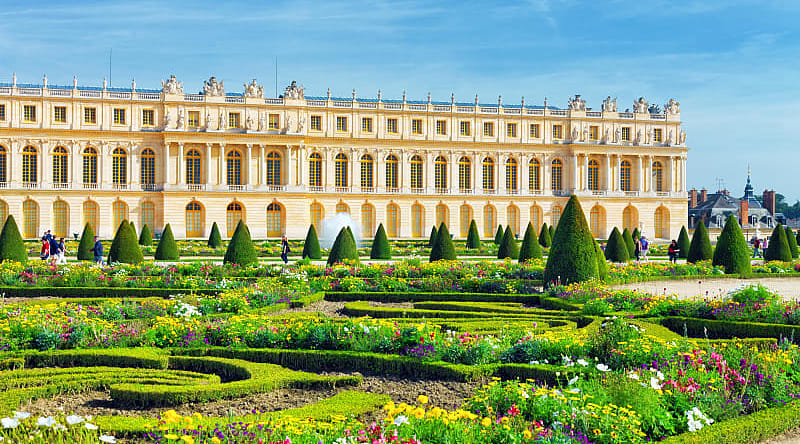 Lush green garden and Versailles building in France Lush green garden and Versailles building in France