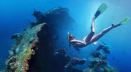 Woman exploring USAT Liberty wreckage off the coast of Bali