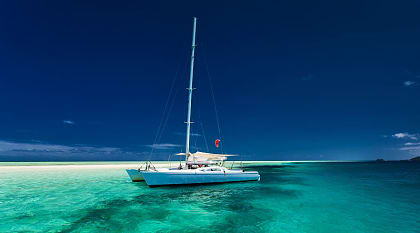 White catamaran on tropical island in Fiji