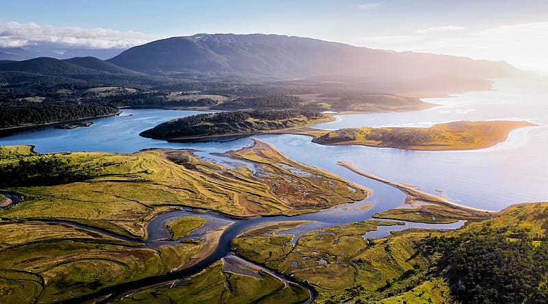 Pampas and Las Vueltas river with Fitz Roy and Cerro Torre peaks in the background, Patagonia, Argentina Beagle Channel, Tierra del Fuego, Patagonia