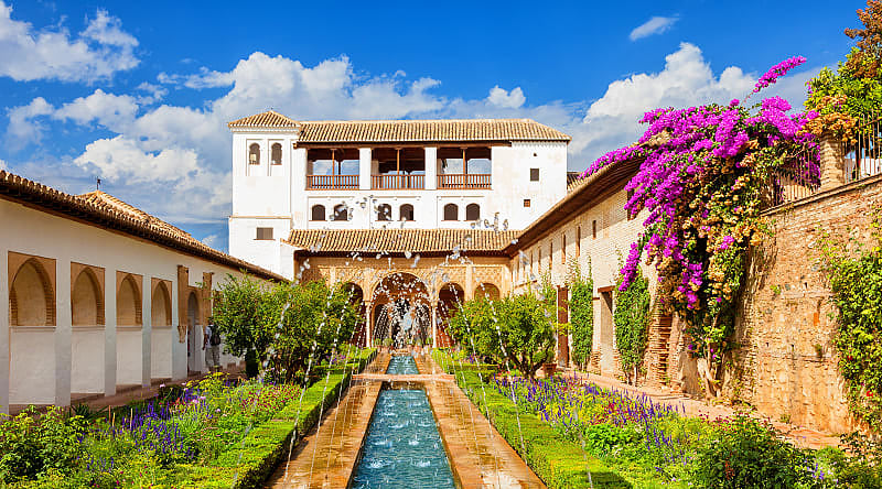 The Generalife with its famous fountain and garden at Alhambra in Granada, Spain The Generalife with its famous fountain and garden at Alhambra in Granada, Spain