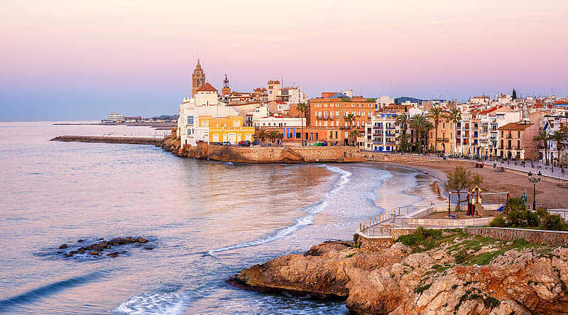 Sand beach and historical Old Town in mediterranean resort Sitges, Spain