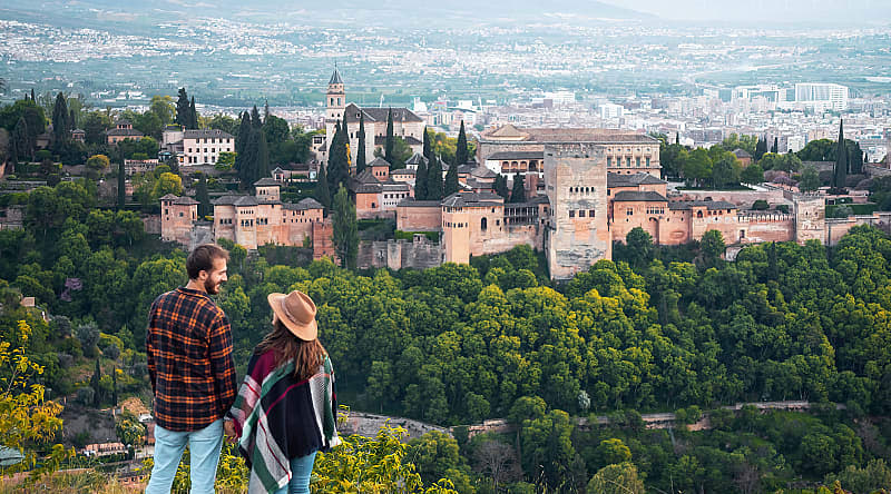 Couple at the Alhambra in Granada, Spain Couple overlooking the Alhambra in Granada, Spain