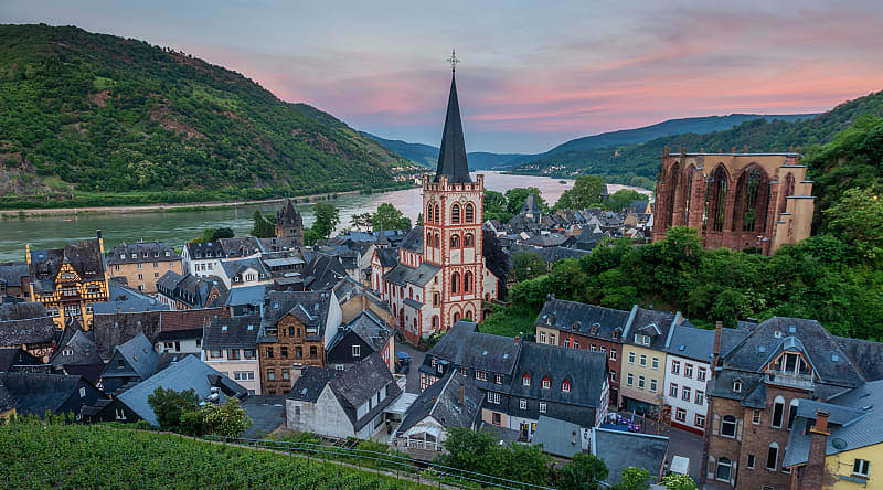Parish Church of St. Peter surrounded by local homes and vineyards Bacharach, Germany during sunset. Parish Church of St. Peter surrounded by local homes and vineyards Bacharach, Germany during sunset.