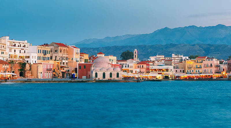 Chania in Crete, Greece Venetian Quay of Chania with Kucuk Hasan Pasha Mosque during twilight blue hour, Crete, Greece