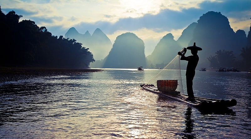 Fisherman at Lijiang river in China Fisherman at Lijiang river in China