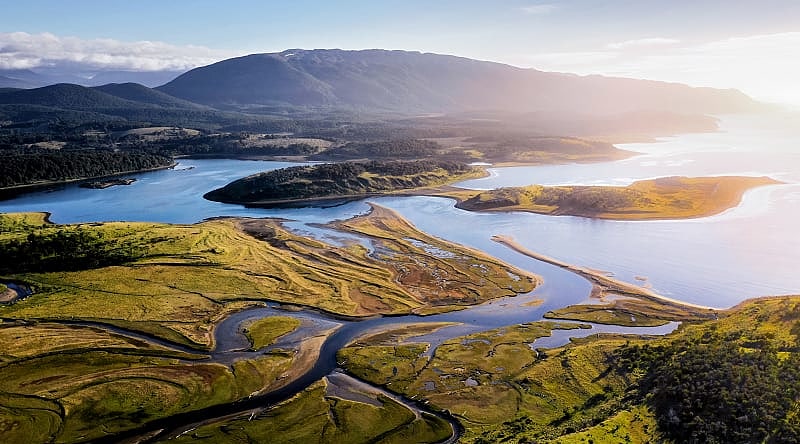 Pampas and Las Vueltas river with Fitz Roy and Cerro Torre peaks in the background, Patagonia, Argentina Beagle Channel, Tierra del Fuego, Patagonia