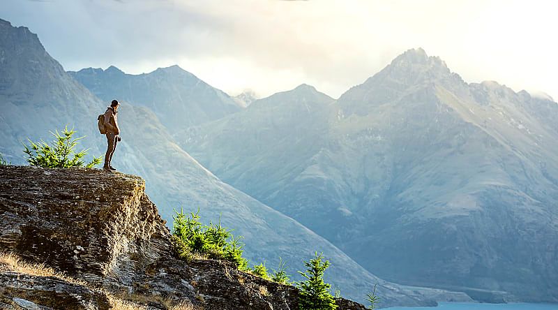 Queenstown, New Zealand Hiker looking over lake in Queenstown, New Zealand
