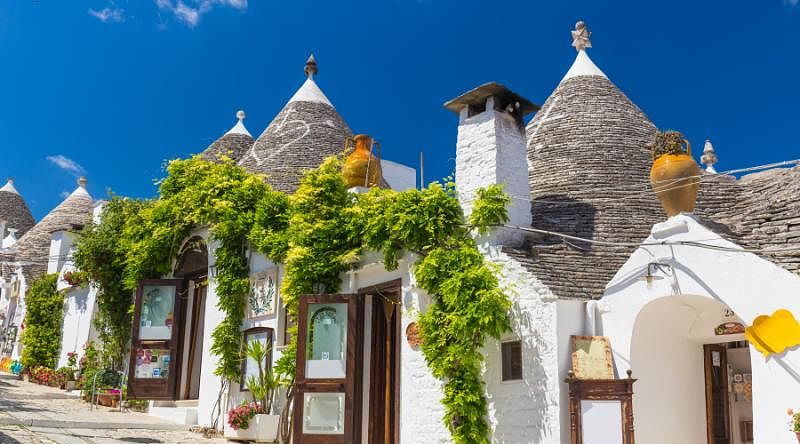 Luxuries of Puglia to Amalfi Coast Tour White circular Trulli houses of Alberobello in the Puglia region of Italy